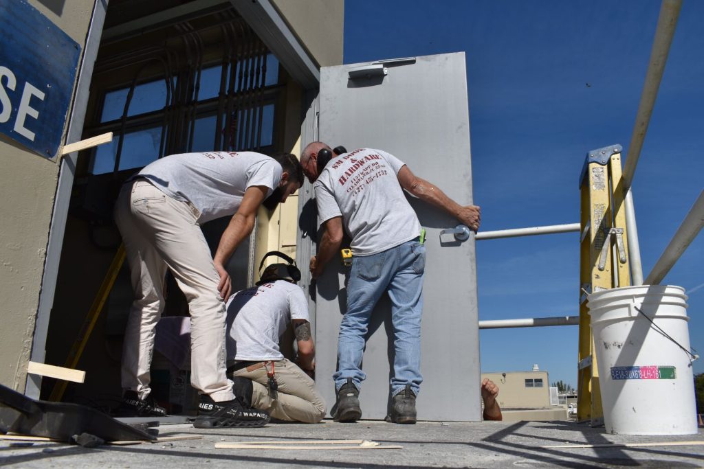 SM Door Workers repairing a commercial door